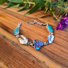 Load image into Gallery viewer, Sterling Roots silversmith Emily Dicob forging silver at the bench in her Northern New York studio surrounded by Adirondack inspiration.