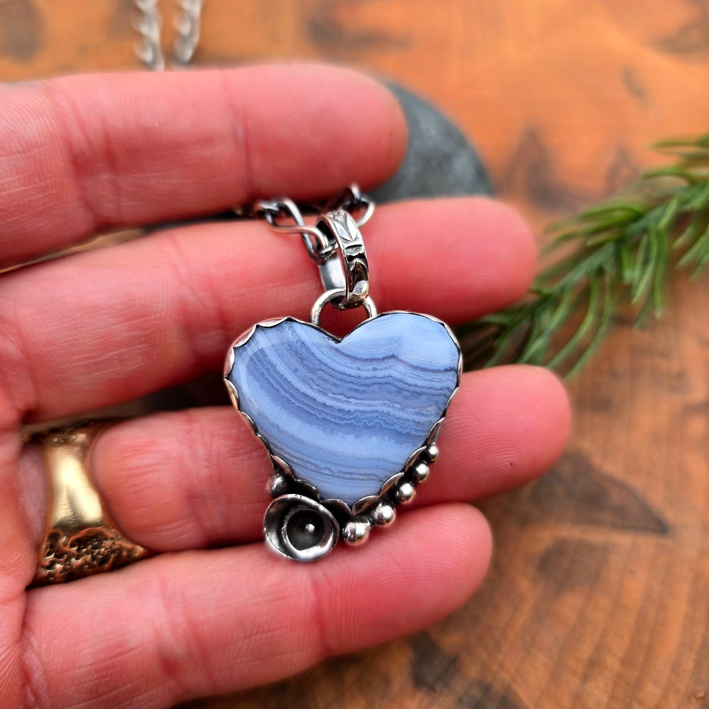 Sterling silver heart shaped crazy lace agate pendant with floral accent