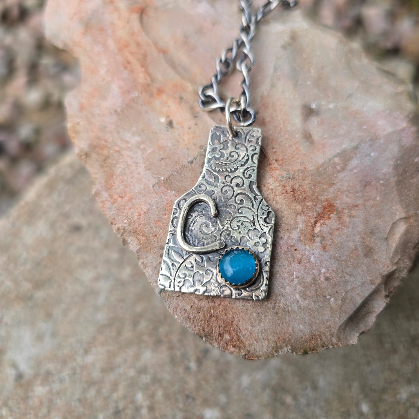 Hand-Forged Floral Cow Tag Sterling Silver Pendant with Blue Cats Eye