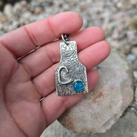 Hand-Forged Floral Cow Tag Sterling Silver Pendant with Blue Cats Eye