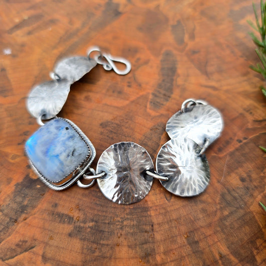 Detail of rainbow moonstone set in sterling silver concho