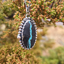 Load image into Gallery viewer, Sterling and Royston Ribbon turquoise pendant hanging from chain with natural background side view