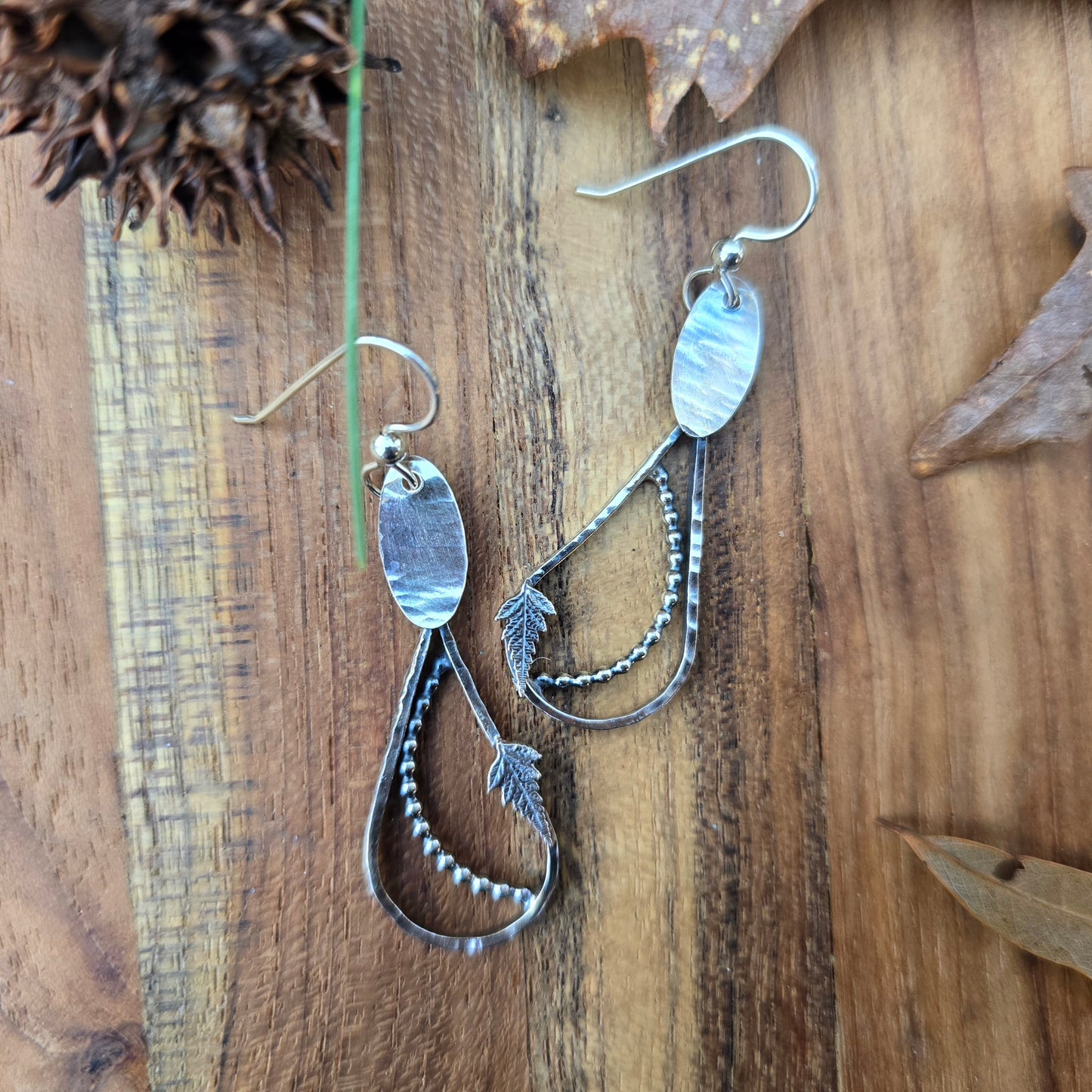 silver fern and raindrop earrings top view
