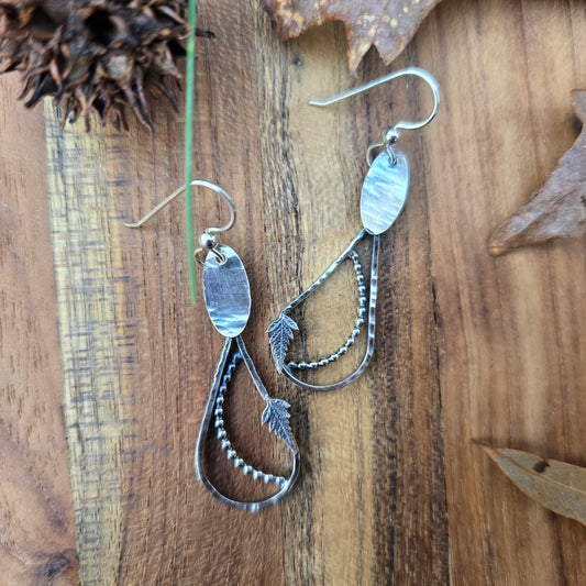 silver fern and raindrop earrings top view