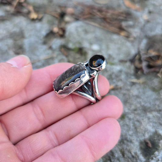 sterling obsidian and black onyx statement ring displayed on hand