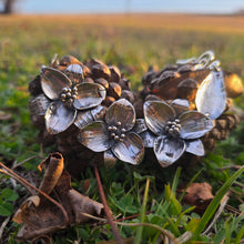 Load image into Gallery viewer, Triple trillium statement necklace displayed on pinecones and grass