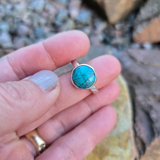 turquoise ring with minimal bezel and sterling silver band worn on hand