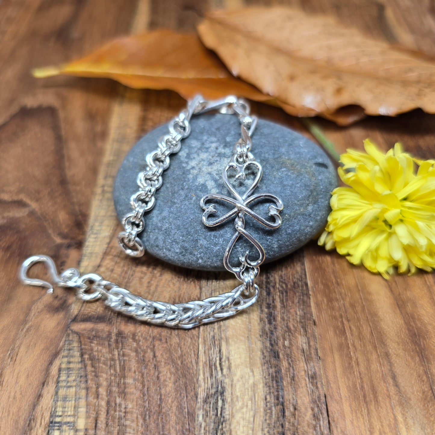 Adirondack silversmith Shane Dicob’s hand-forged sterling silver chainlink bracelet featuring a Twisted Heart Cross link.