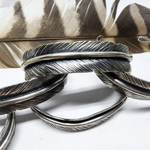 Load image into Gallery viewer, silver feather cuff bracelets stacked on top of each other