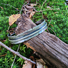 Load image into Gallery viewer, silver feather cuff bracelet on log in moss