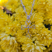 Load image into Gallery viewer, Artisan-crafted sterling silver cross and hearts pendant symbolizing strength and grace.
