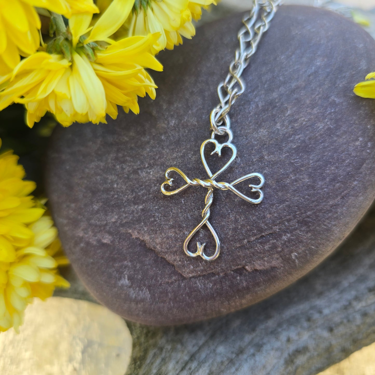 Traditional silversmith-crafted tiny cross pendant — forged by hand in silver.