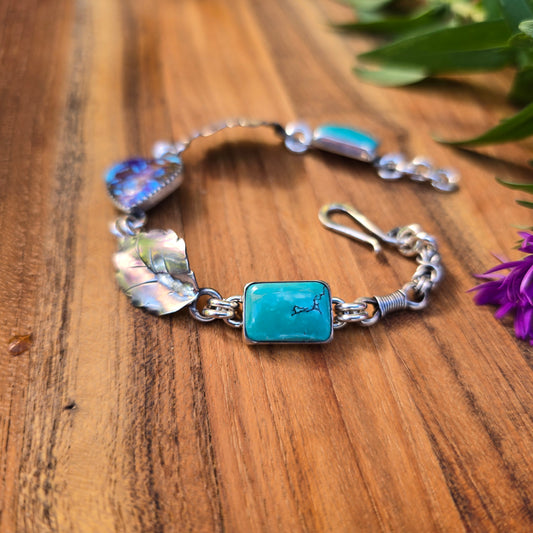 Adirondack silversmith Emily Dicob shaping sterling silver components for a handcrafted turquoise bracelet in her Northern New York studio.