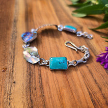 Load image into Gallery viewer, Adirondack silversmith Emily Dicob shaping sterling silver components for a handcrafted turquoise bracelet in her Northern New York studio.
