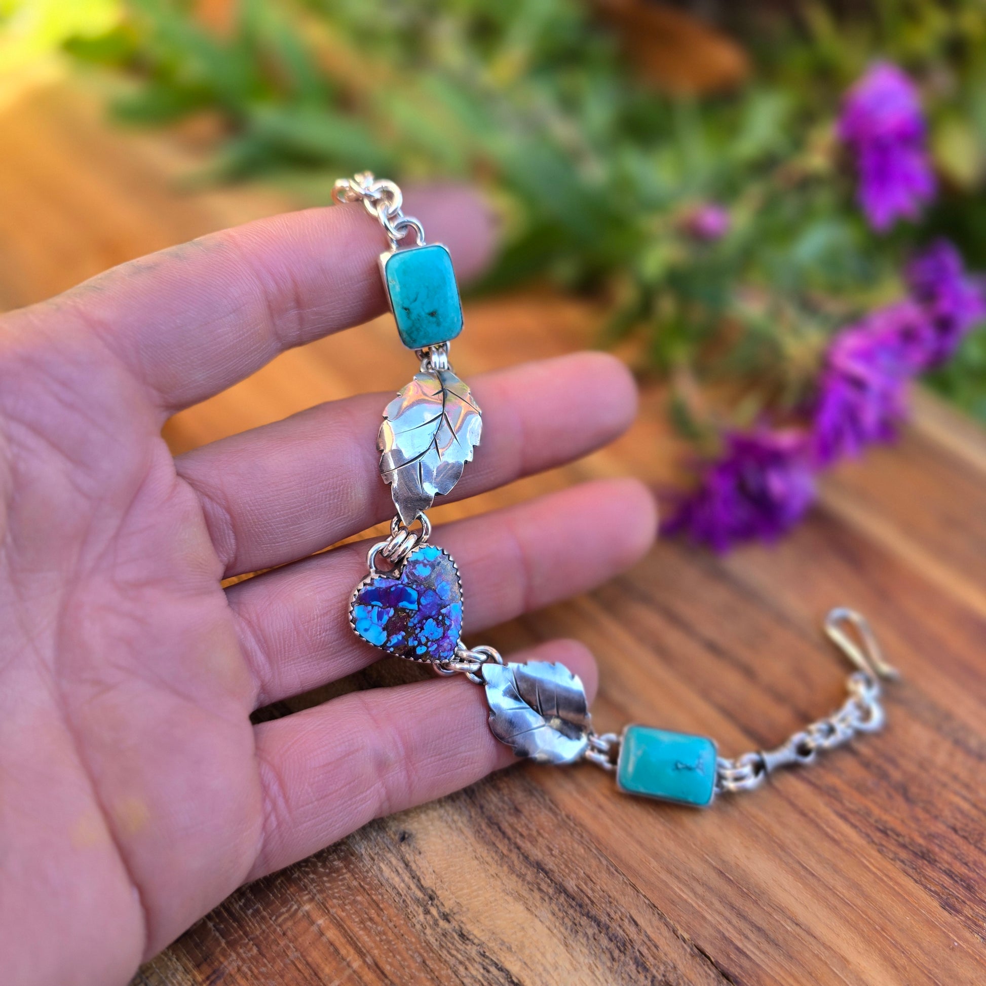 Vibrant turquoise stones set in sterling silver bracelet, designed and hand-forged by Emily Dicob, Adirondack silversmith.