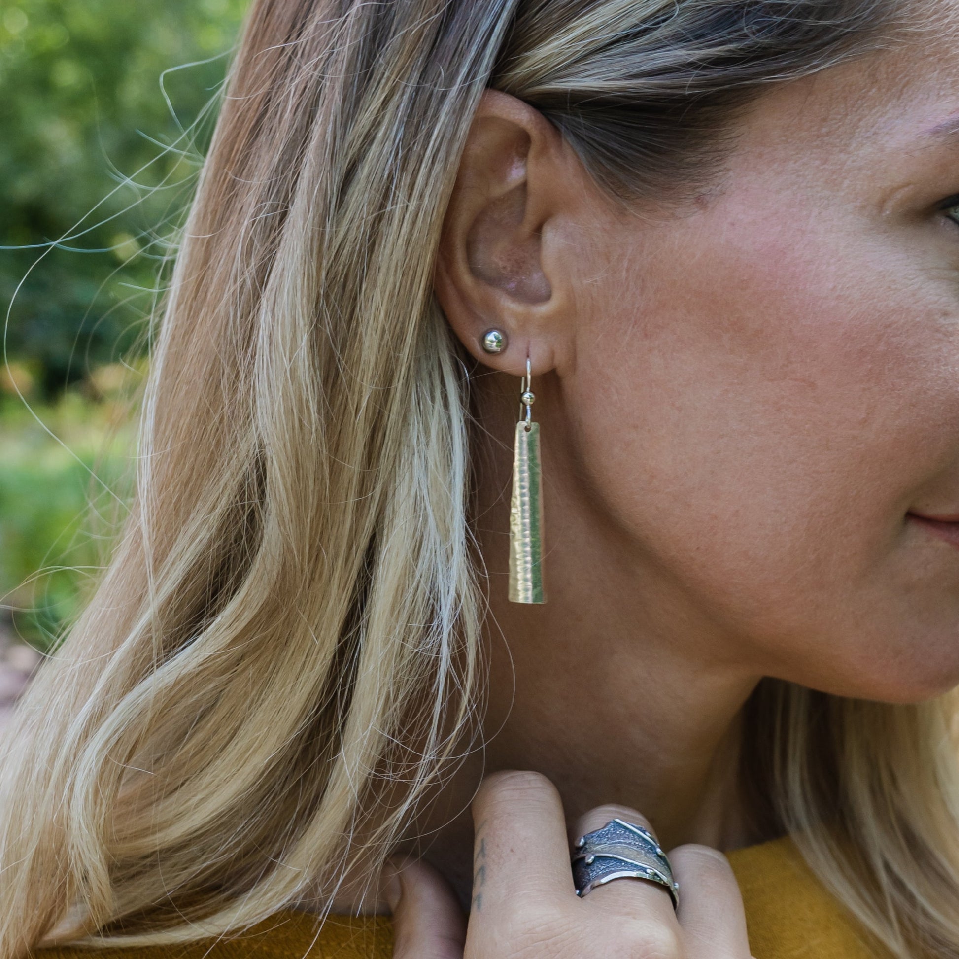 lifestyle photo of Emily Dicob wearing handcrafted earrings
