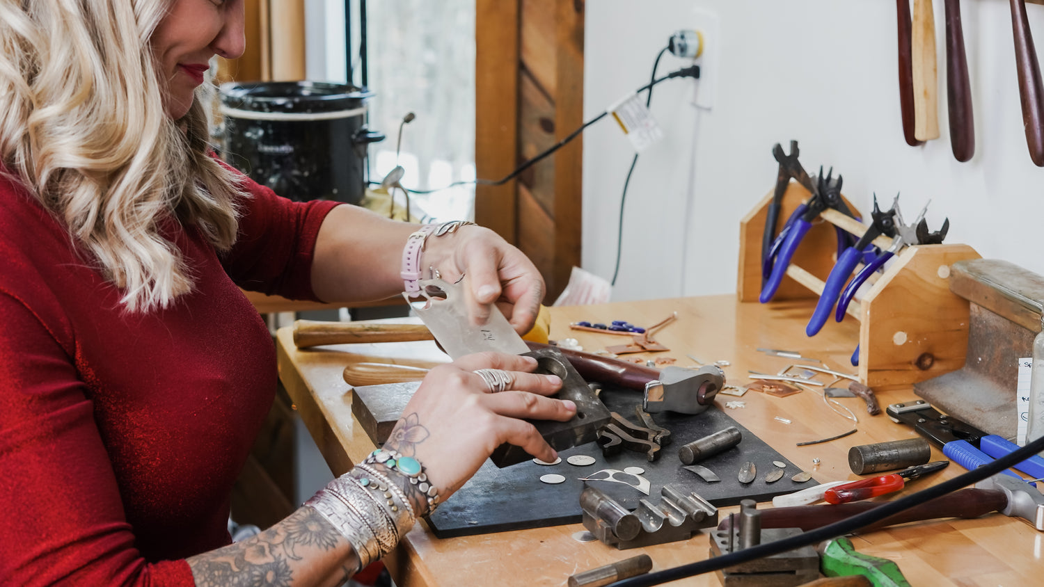 Emily Dicob, Sterling Roots silversmith forging sterling silver foundational forms of jewelry in her studio using traditional tools.