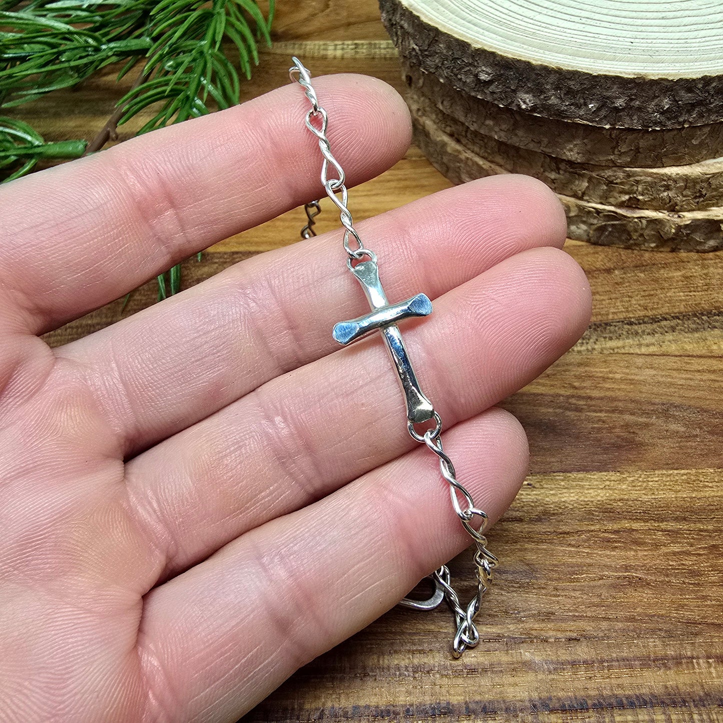 Sterling silver cross detail on hand-forged bracelet