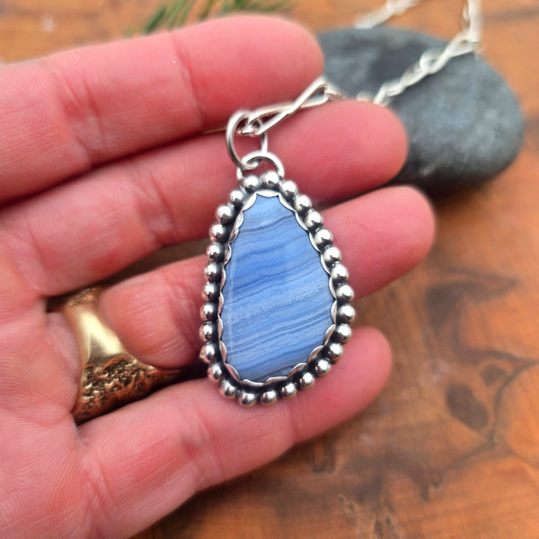 Large periwinkle agate bead set in sterling silver pendant