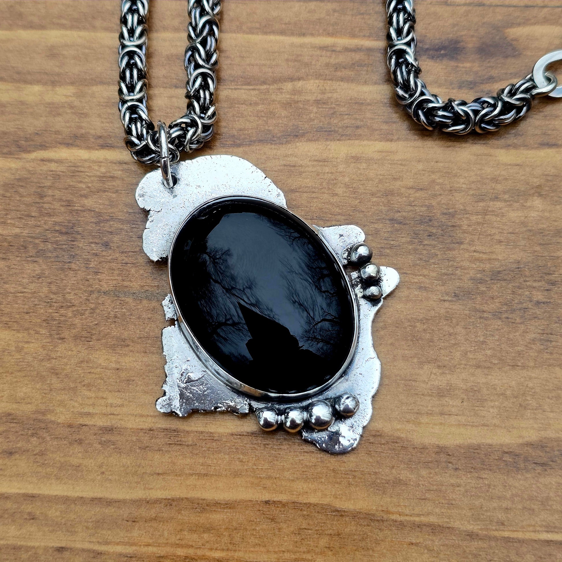 large black onyx pendant paired with sterling silver byzantine chain