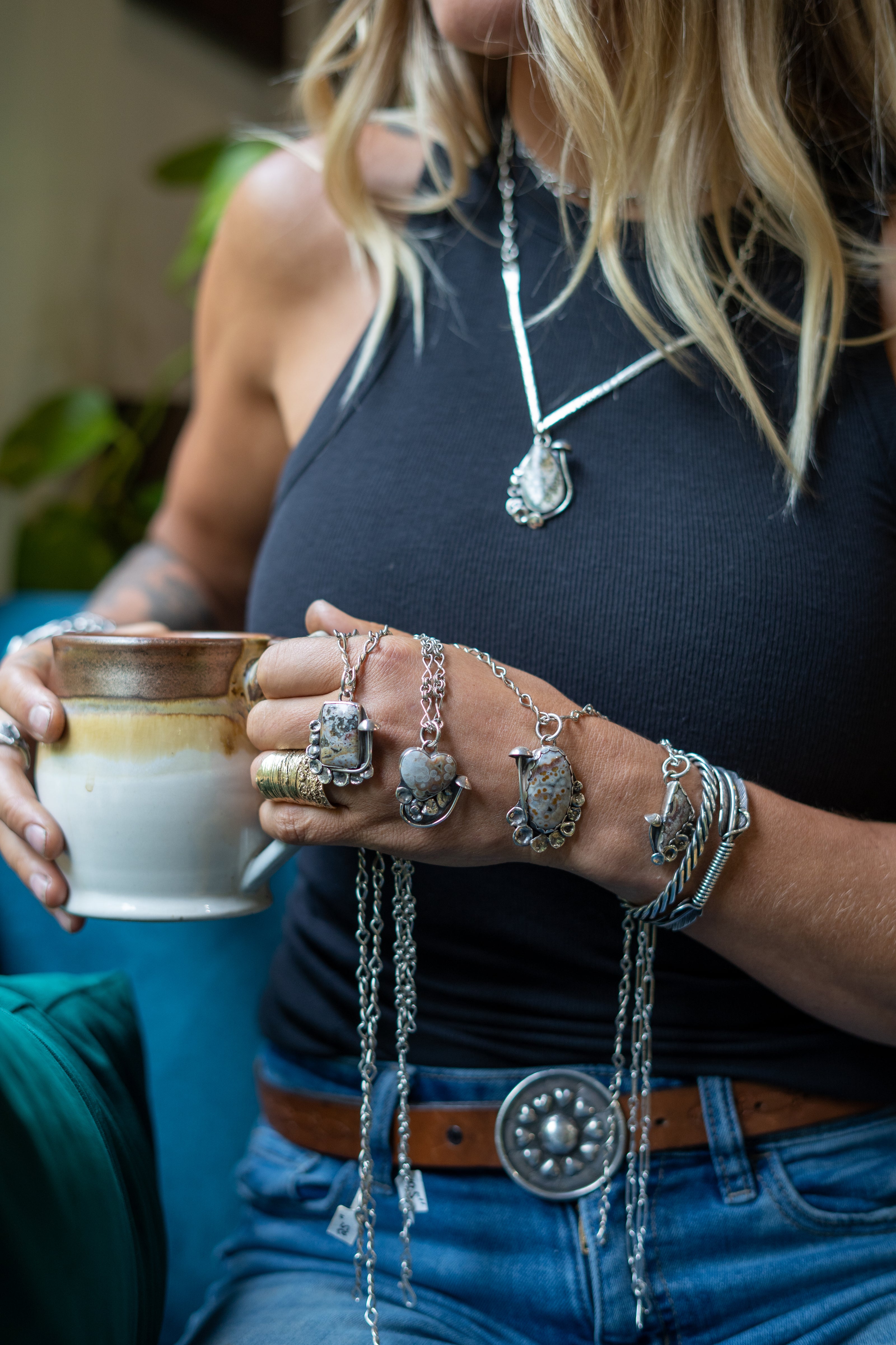 A collection of hand-forged sterling silver jewelry inspired by the natural world worn by Emily Dicob of Sterling Roots.
