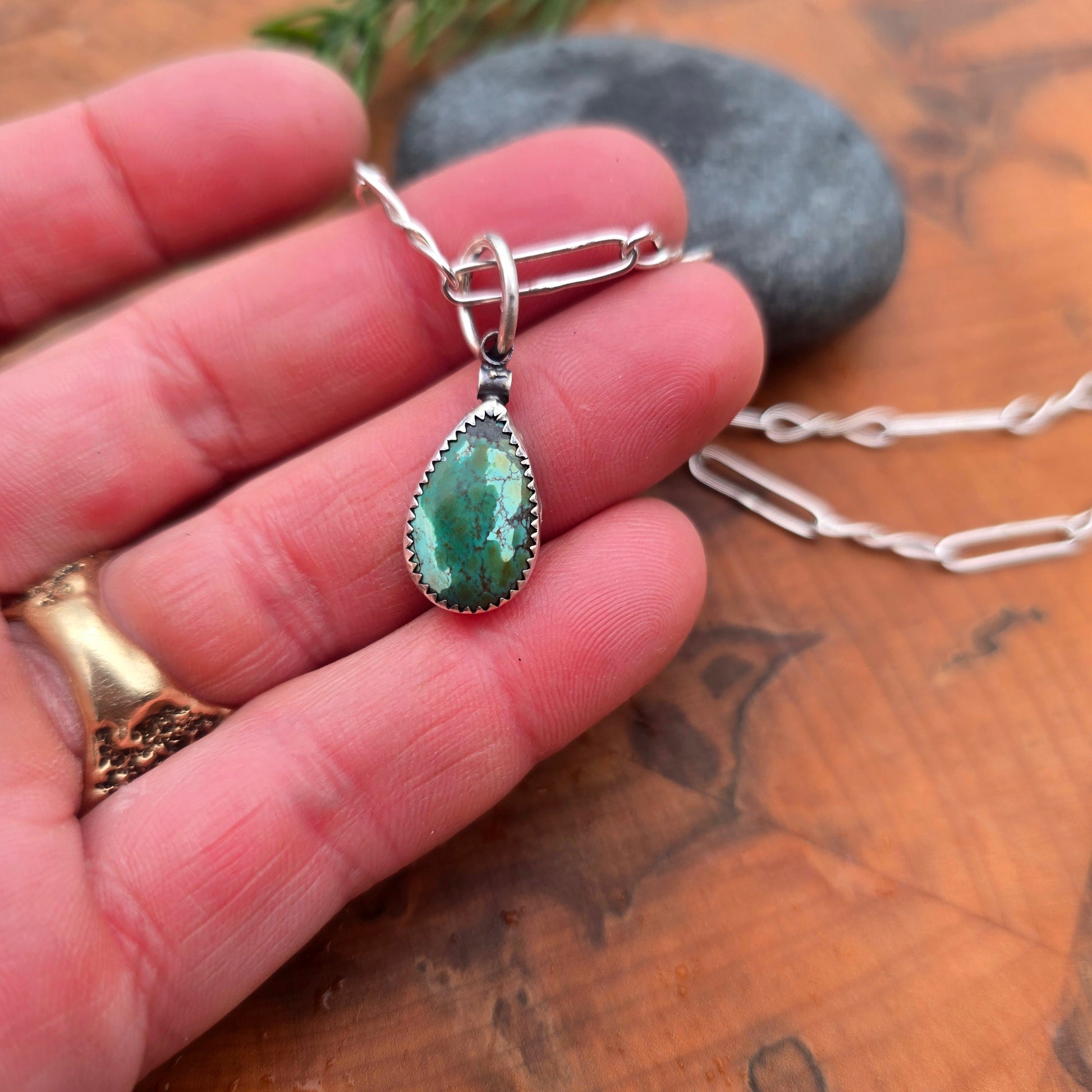Detail of raindrop-shaped turquoise in sterling silver pendant
