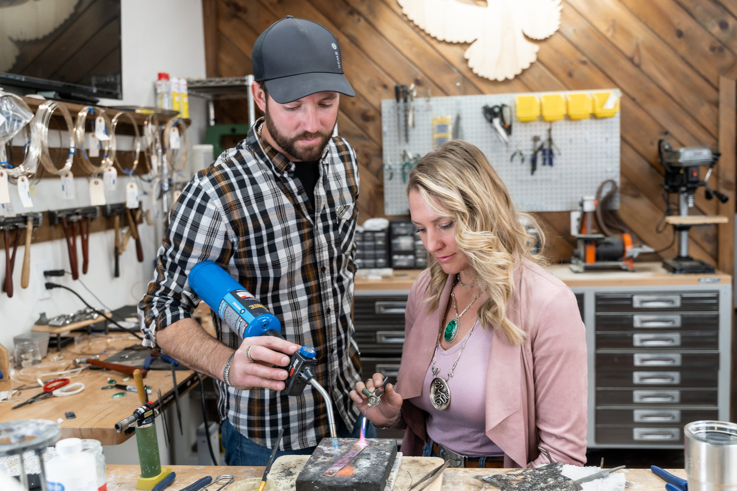 Emily Dicob and Shane, Adirondack silversmiths, building hand-forged jewelry at the Sterling Roots studio bench.