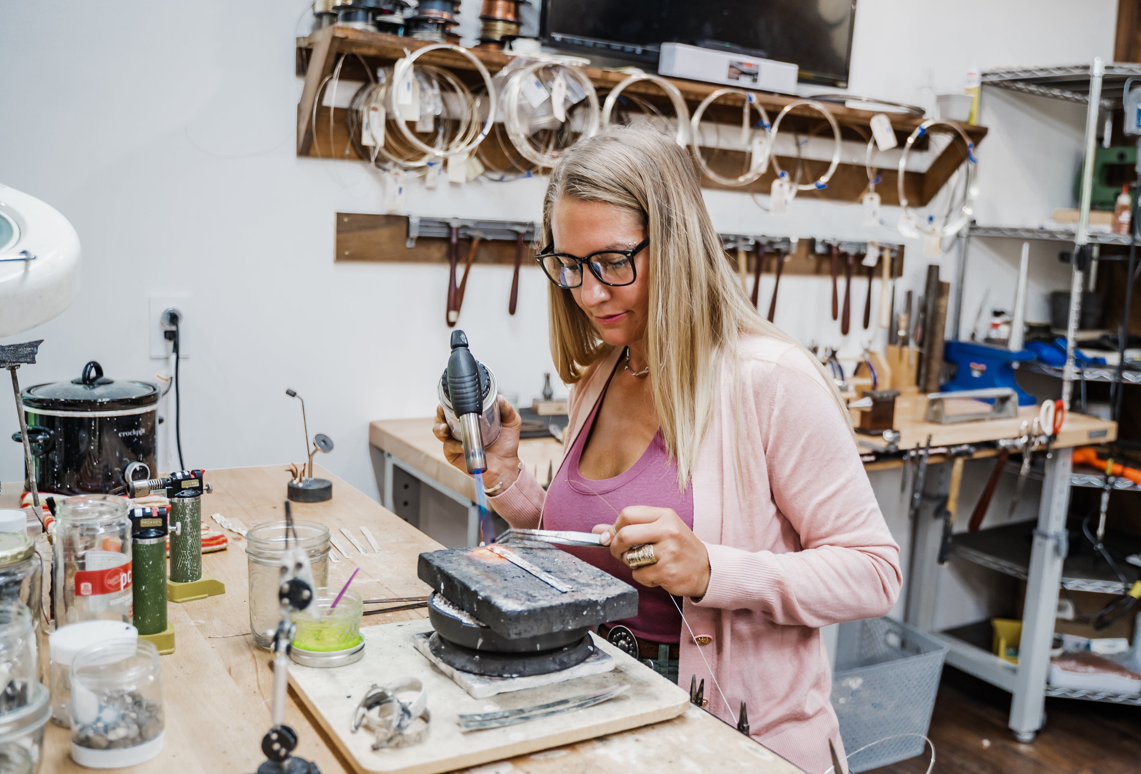 Emily Dicob of Sterling Roots forging sterling silver jewelry on her soldering block in her Adirondack Foothills studio.