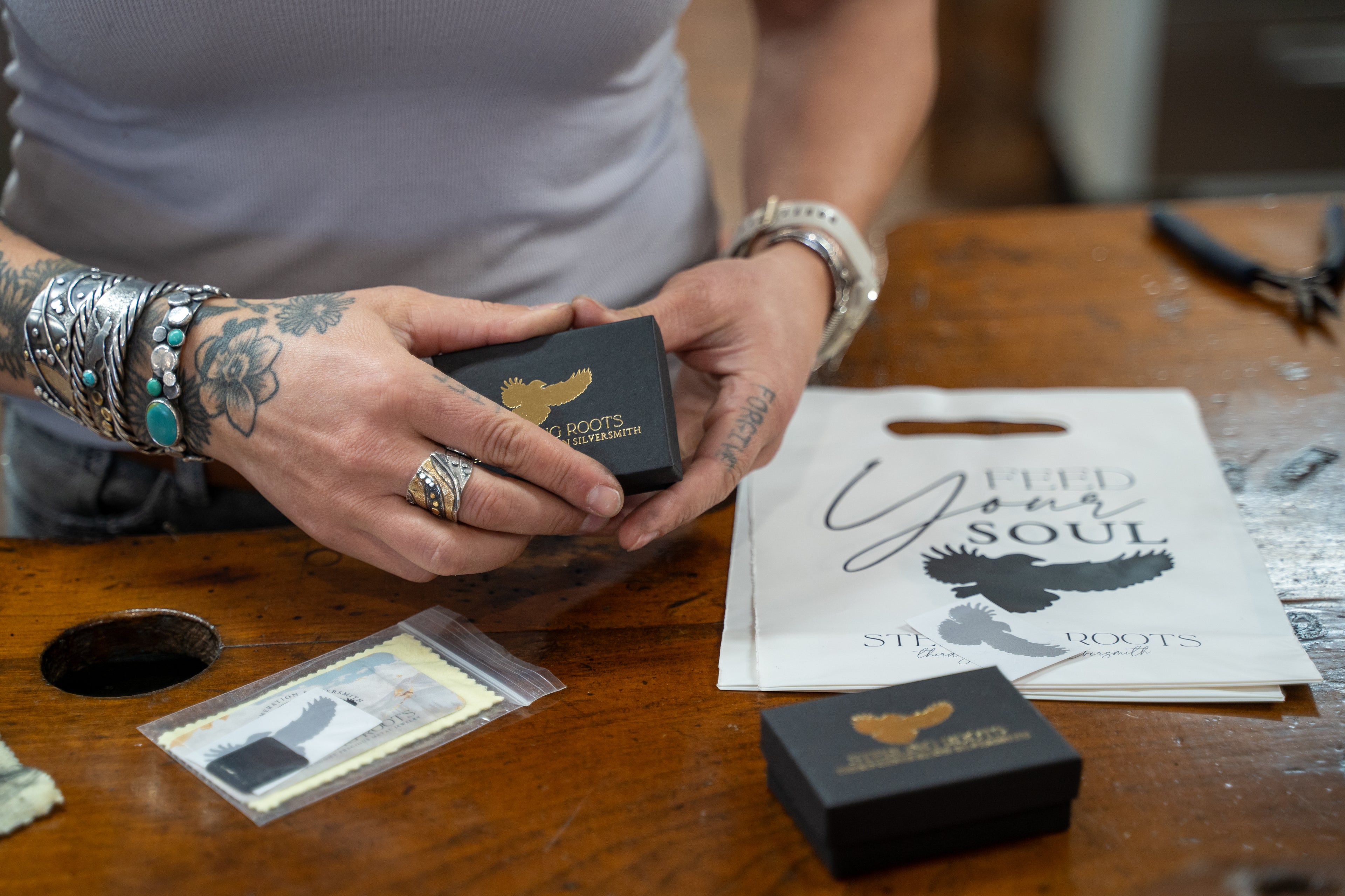 Emily Dicob of Sterling Roots packaging hand-forged jewelry in branded box.