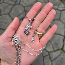 Load image into Gallery viewer, fern frond pendant with gold accent and dainty fern frond pendant displayed together on handmade chains on hand
