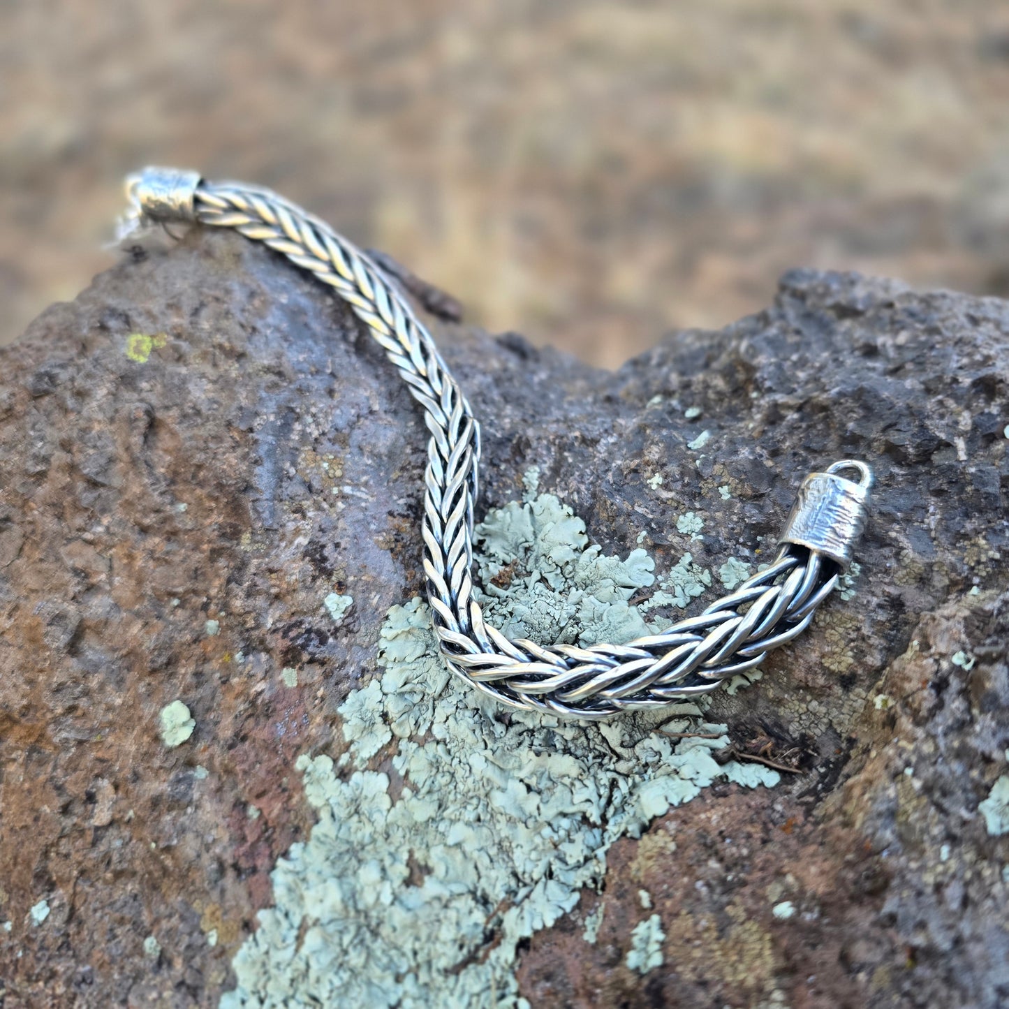 Handwoven sterling silver foxtail men’s bracelet formed link by link with a solid chain structure and substantial weight.