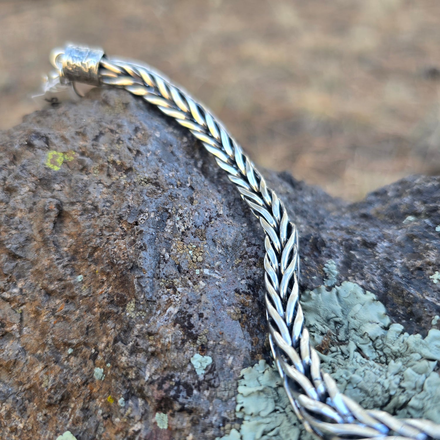 Handwoven sterling silver foxtail chain bracelet with reticulated silver end caps and a handmade clasp, built one piece at a time and sized for a 7.5–8 inch wrist.