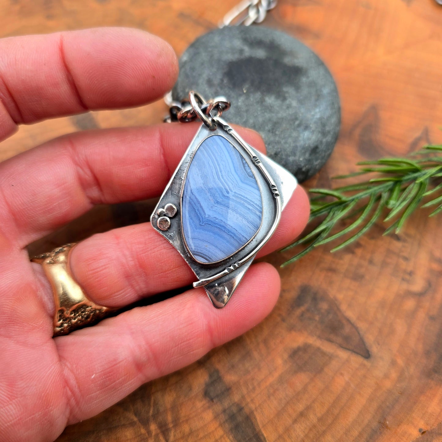 Detail of crazy lace agate in geometric sterling silver pendant