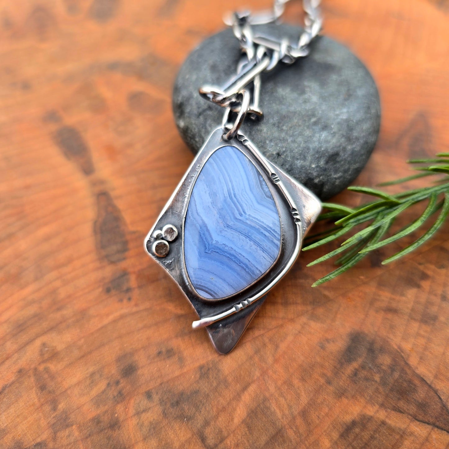Crazy lace agate set in geometric sterling silver pendant