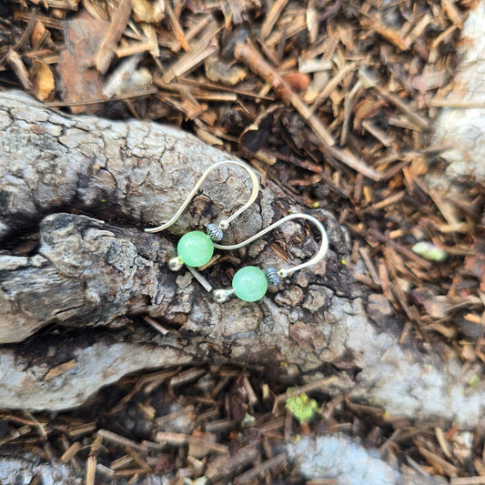 silver and green cats eye threader earrings top view