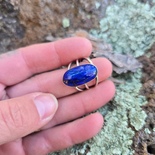 Sterling silver and lapis lazuli ring displayed on finger.