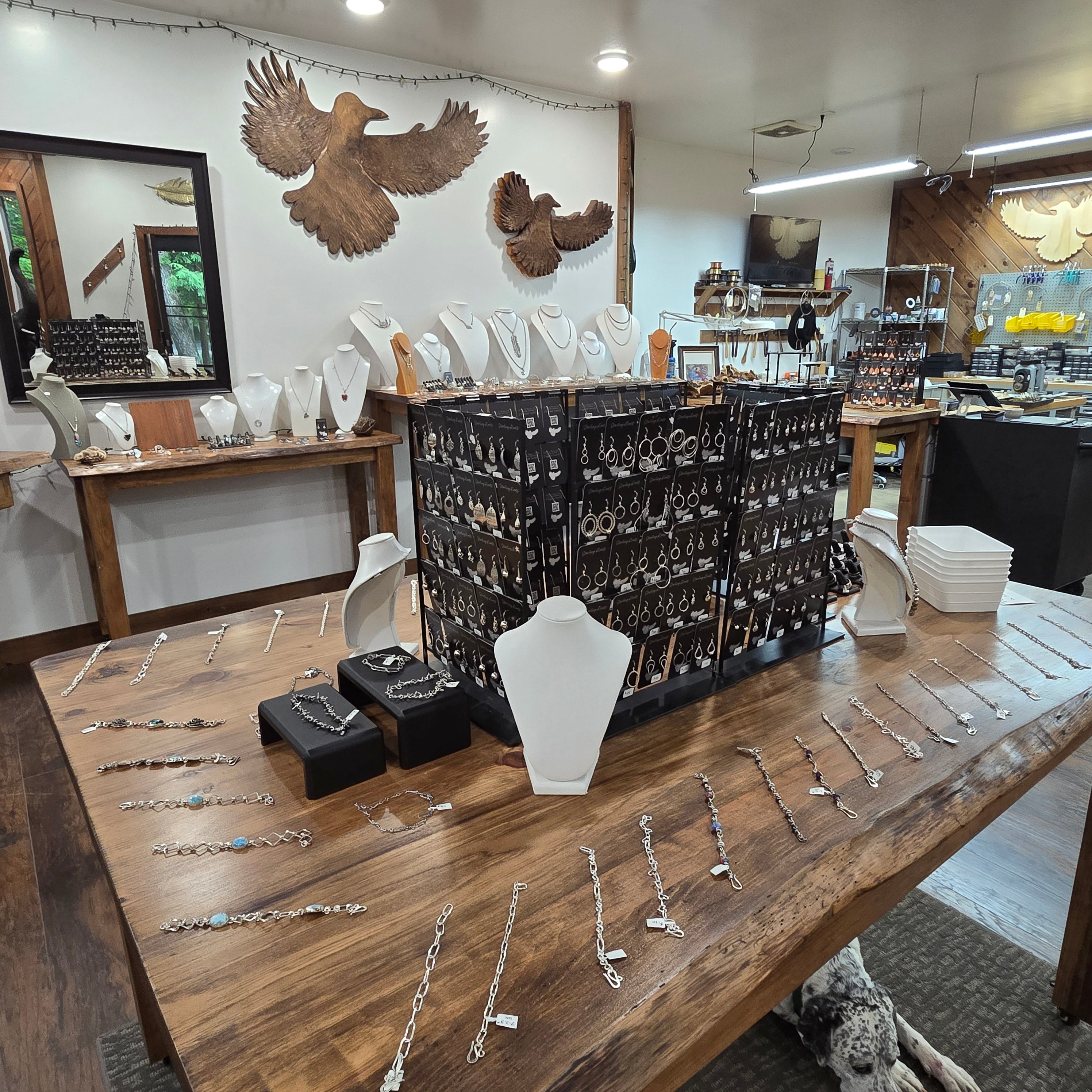 Detailed view of Sterling Roots Studio interior with hand-forged jewelry on display with tools in background.