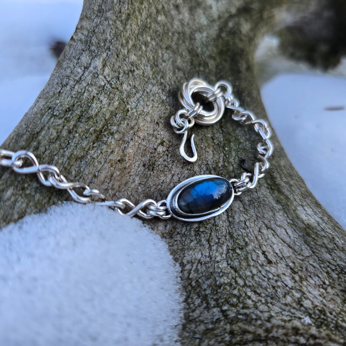 detail shot of handmade clasp on sterling silver infinity link bracelet