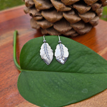 Load image into Gallery viewer, pair of sterling silver leaf threader earrings displayed on surface
