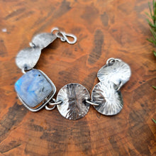 Load image into Gallery viewer, Detail of rainbow moonstone set in sterling silver concho
