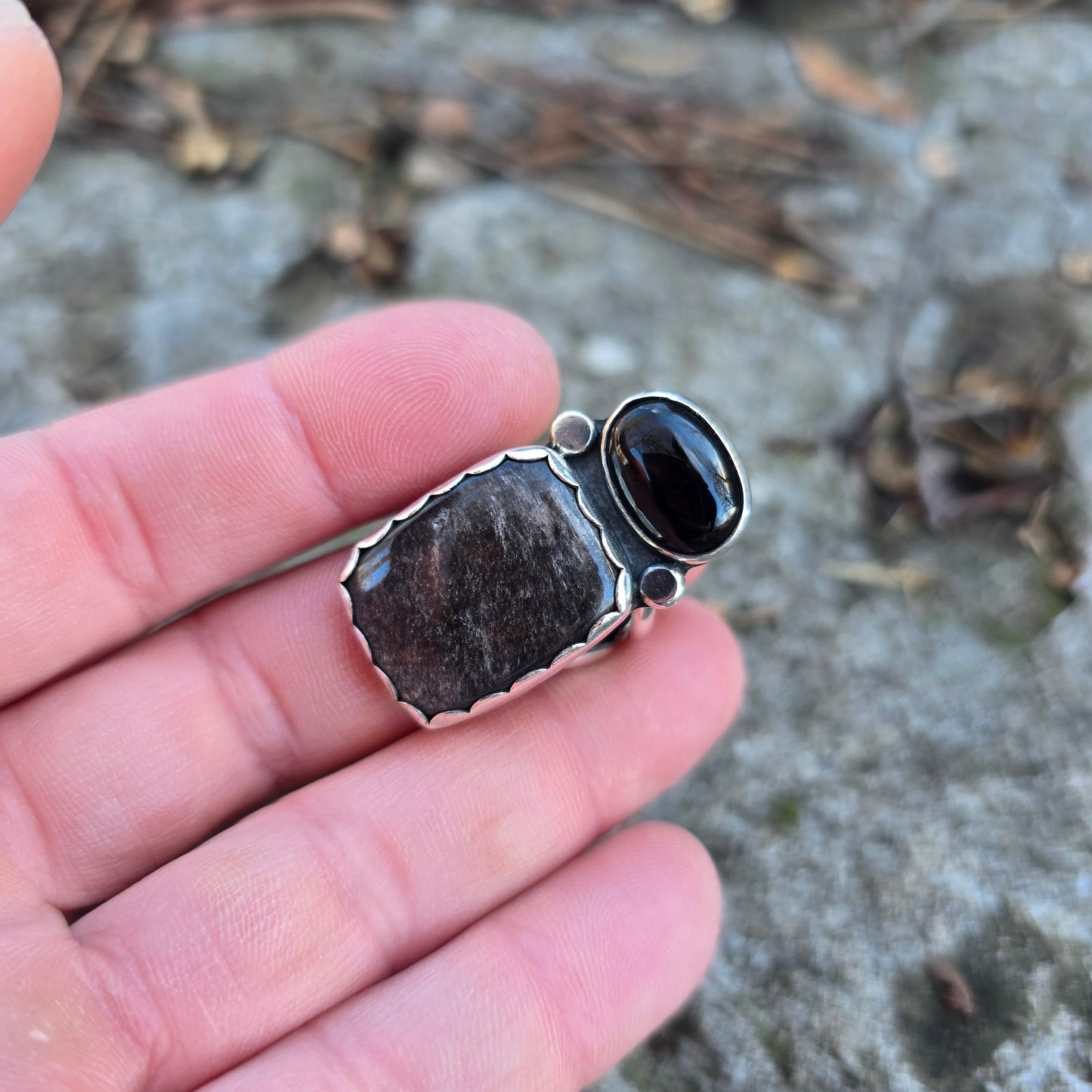 black and silver ring displayed on finger