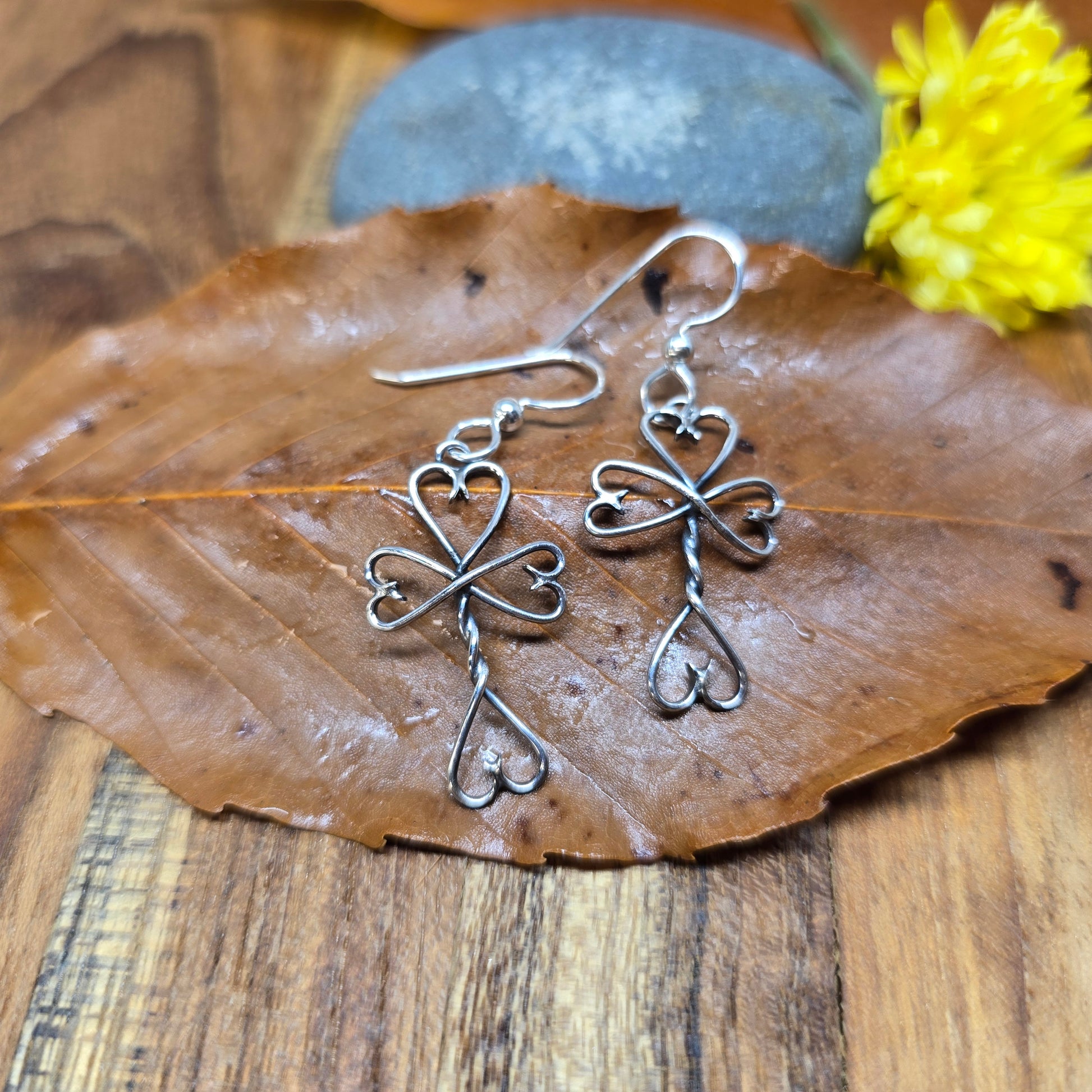 Hand-forged sterling silver Twisted Heart Cross earrings with oxidized finish, crafted in the Adirondacks by Emily Dicob.
