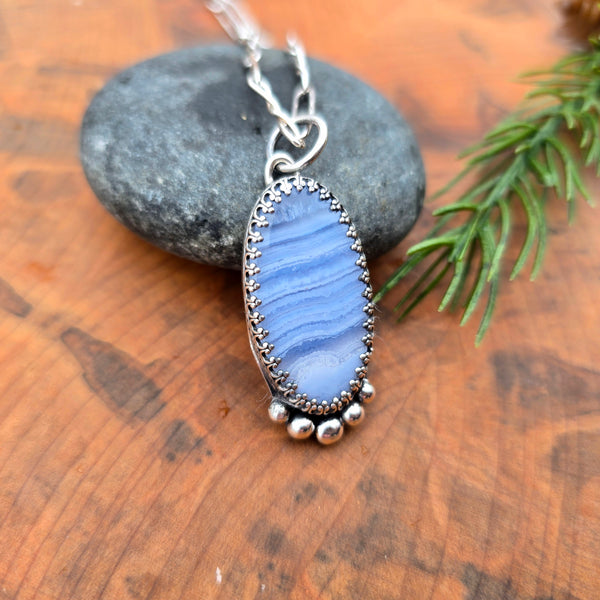 Detail of periwinkle crazy lace agate in sterling silver pendant