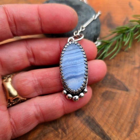 Periwinkle crazy lace agate oval pendant in sterling silver