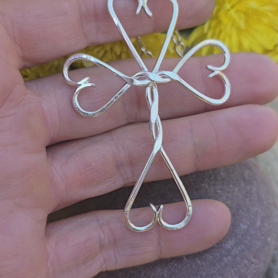 Video of handmade sterling silver cross with twisted accents and hearts forged by Sterling Roots