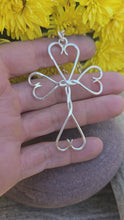 Load and play video in Gallery viewer, Video of handmade sterling silver cross with twisted accents and hearts forged by Sterling Roots
