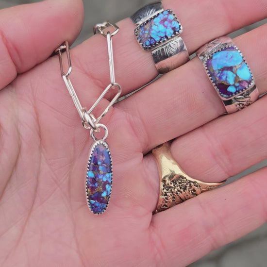 purple mohave turquoise wide band rings and dainty pendant displayed together