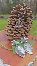 Load and play video in Gallery viewer, video showing sterling silver trillium pendant, three-trillium necklace, and large trillium earrings with leaf drops
