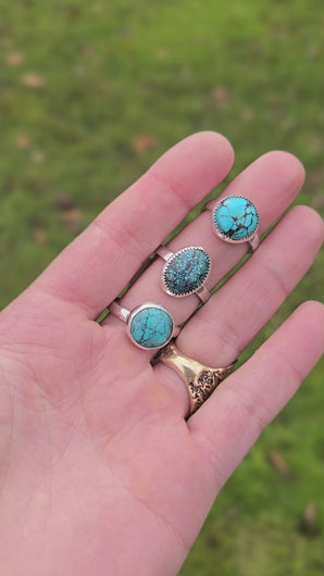 video showing three minimal turquoise rings worn on finger being moved for display