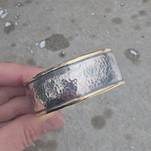 Load and play video in Gallery viewer, Sterling silver hammed cuff with bronze perimeter rotating in hand
